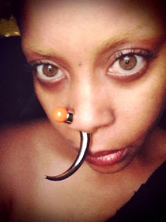 Erykah Badu shows a new look with a rose ring.