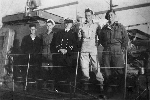 Four of the crew members of Motor Launch (ML) 1321 and NX73110 Sapper (Spr) Edgar Thomas 'Mick' Dennis, Z Special Unit, the only survivor of the ill fated raid on Muschu Island (off the coast of New Guinea), at Brisbane dockyard; May 1945