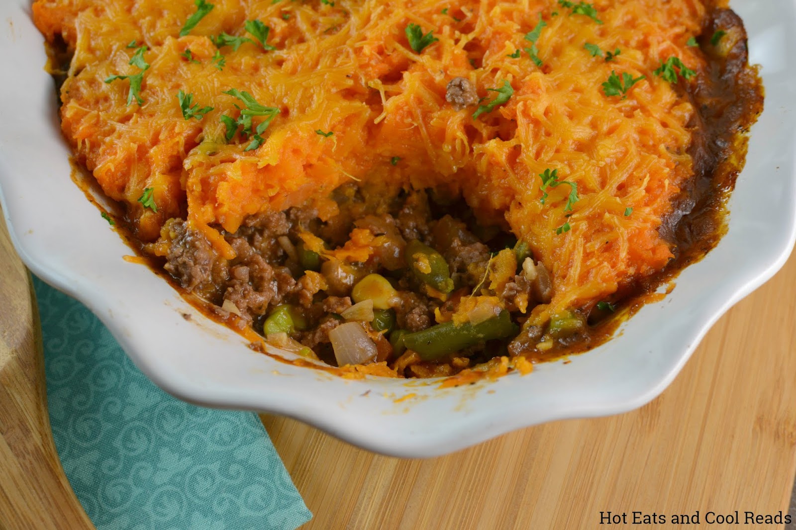 Sweet Potato Beefy Shepard's Pie Recipe from Hot Eats and Cool Reads! This comfort food casserole is perfect for dinner! Topped with delicious mashed sweet potatoes and packed with delicious ground beef and vegetables!