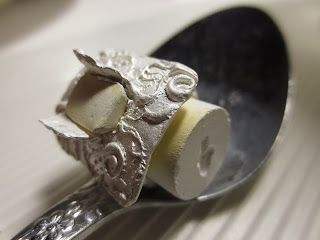 metal clay ring is covered in a white coating when taken from the kiln