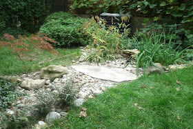 Dry stream bed rain garden hiding disconnected downspout by garden muses: a Toronto gardening blog