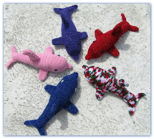 A pod of plush dolphins in crochet