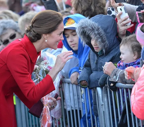 Kate Middleton wore a Ribbed Sleeves Wrapped Coat by Canadian designer Sentaler and new red coat by Venezeulan-American fashion designer Carolina Herrera, Tod's pumps