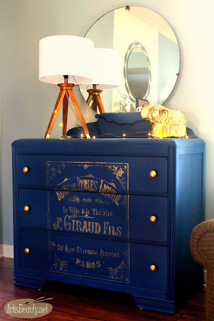 Vintage thrifted dresser painted a glossy deep cobalt blue decorated with bohemian accents