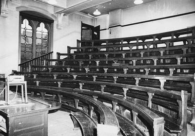 Old bench style seating in lecture hall at University of Glasgow