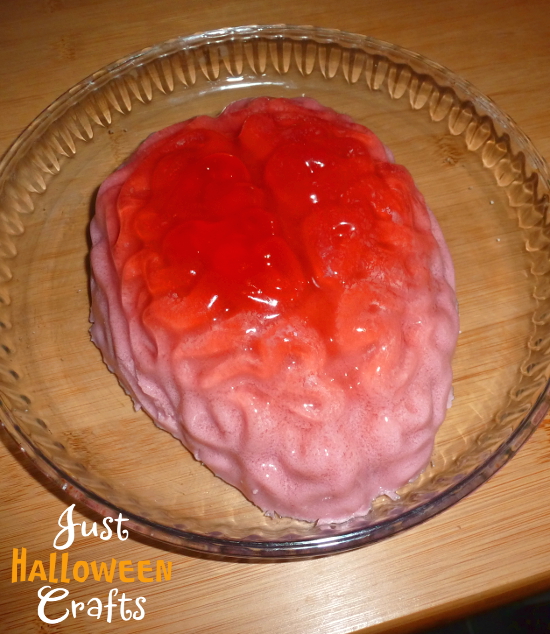 pink and red brain made from jello on on a glass plate dish