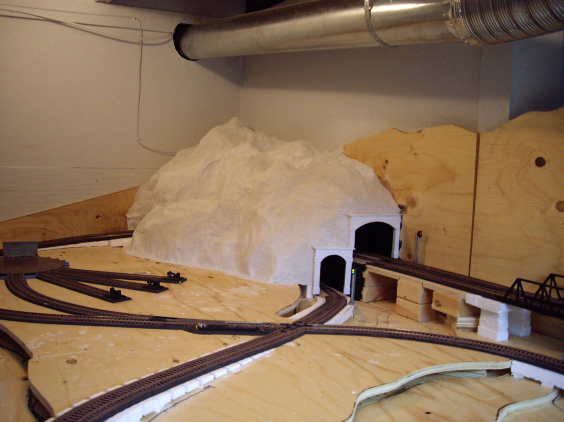 Completed plaster cloth mountain structure over two tunnels with styrene tunnel portals