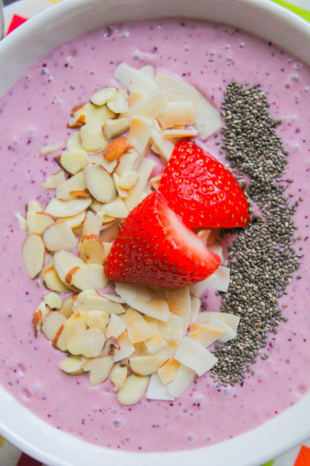 Mixed Berry Smoothie Bowl with Toasted Coconut Chips and Almonds