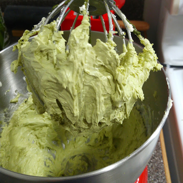 Light green matcha buttercream in a whisk.