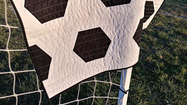 Soccer quilt made with half hexagons