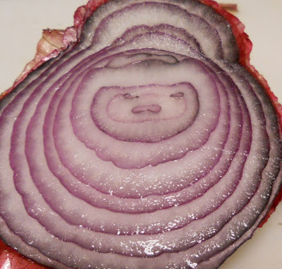 face in a red onion slice