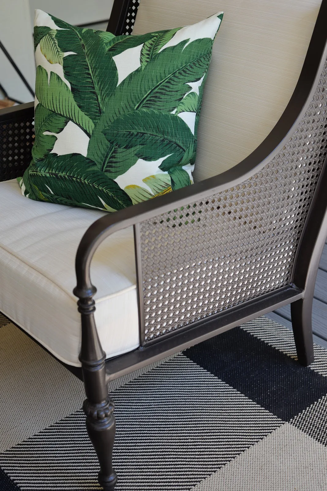 RamblingRenovators.ca | porch decor | outdoor caned chair,  plaid outdoor rug, palm leaves fabric