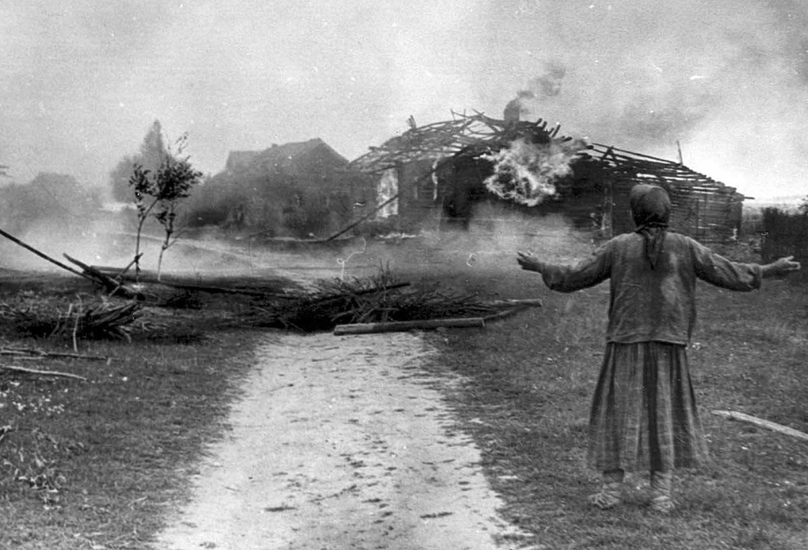 A Russian woman watches building burn sometime in 1942.