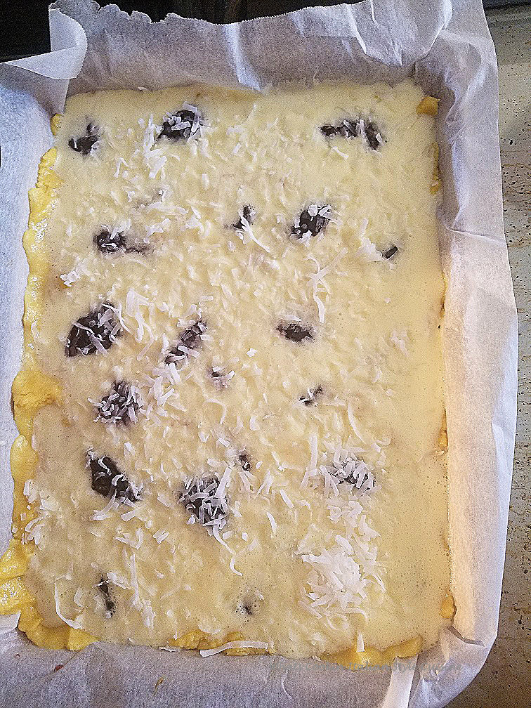 This is an easy bar cookie with a cake mix crust and the filling is a cheesecake batter with raspberry jam swirl and coconut that toasts while baking in the oven
