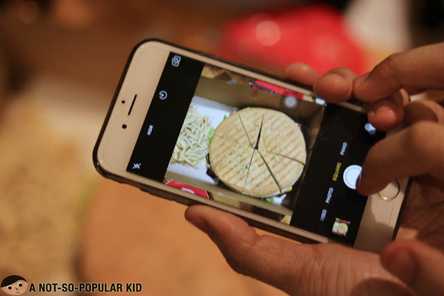 Taking burger using iPhone