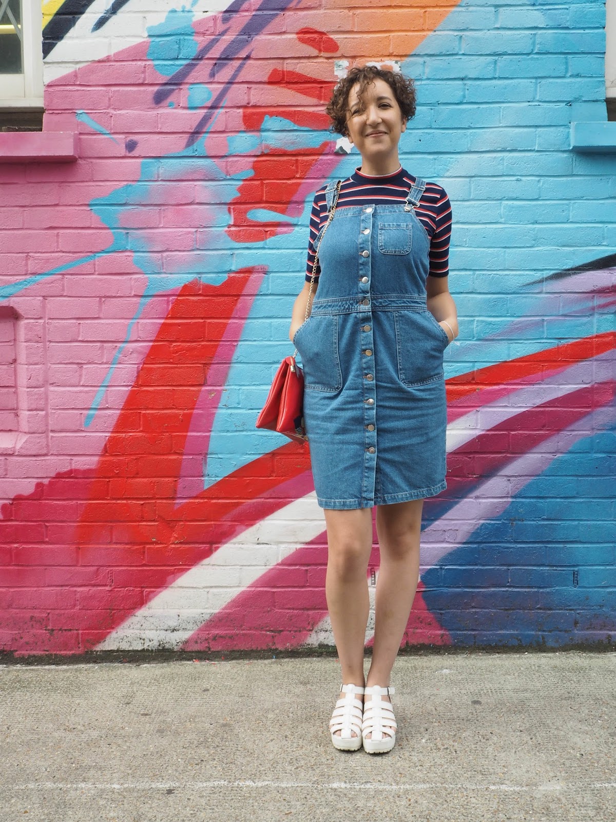 Fashion blogger wearing a denim pinafore dress
