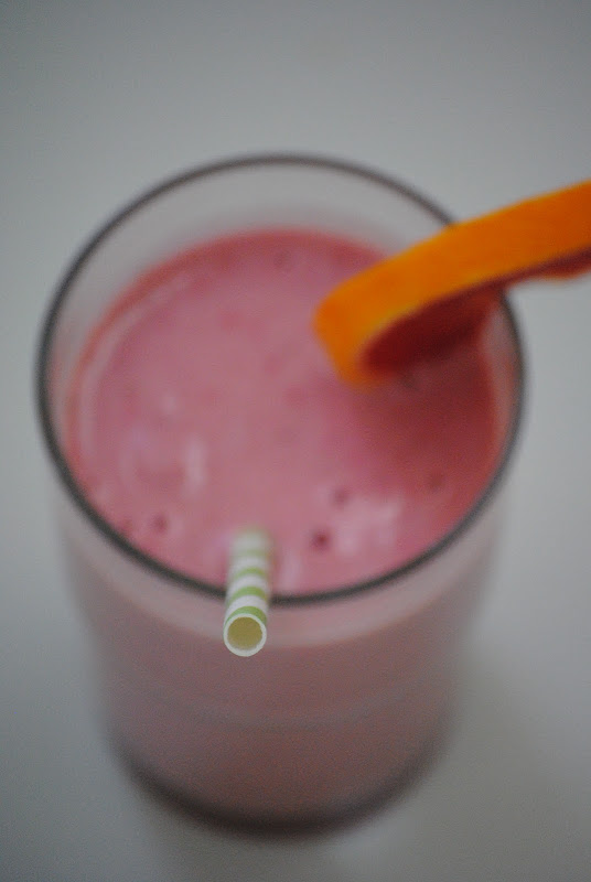 Smoothie with a straw and orange slice