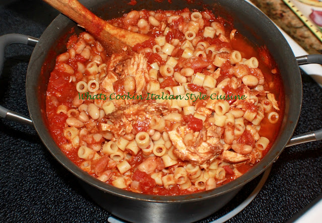 This is a big pan of pasta, sauce and beans with chicken in it.