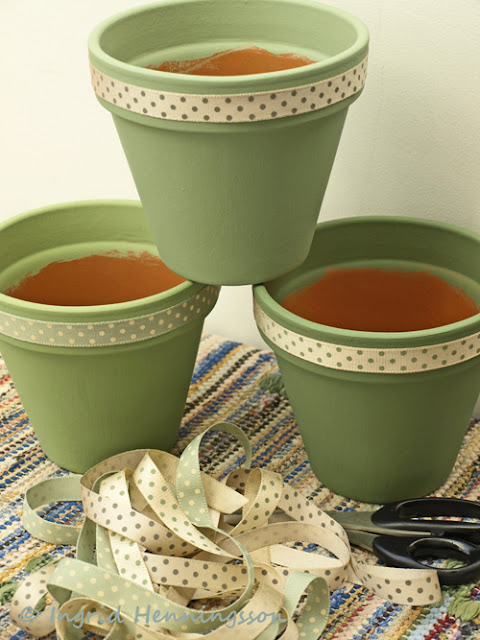 Painted terracotta pots with ribbons