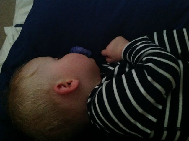 Baby sleeping with red cheek due to earache and sore throat
