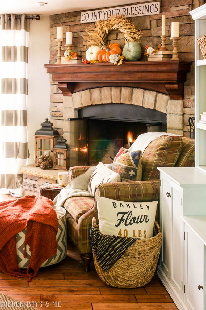 Stone fireplace in family room with fall decor and lanterns - www.goldenboysandme.com