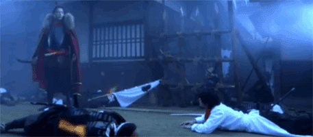 Oikawa Mitsuhiro 及川光博 as Oda Nobunaga stands in battle gear over Tamamori Yuta 及川光博 as Ken 玉森裕太 (たまもり ゆうた) who is laying in a battle torn street.