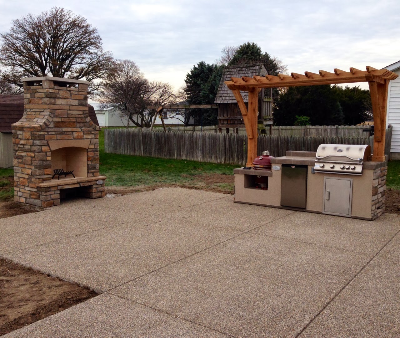 Outdoor Living Exposed Aggregate Patio with a matching kitchen and