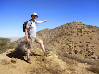 Dan Simpson on the summit of Warren View (4880’+) pointing to Warren Point (5103’), Black Rock Canyon, Joshua Tree National Park