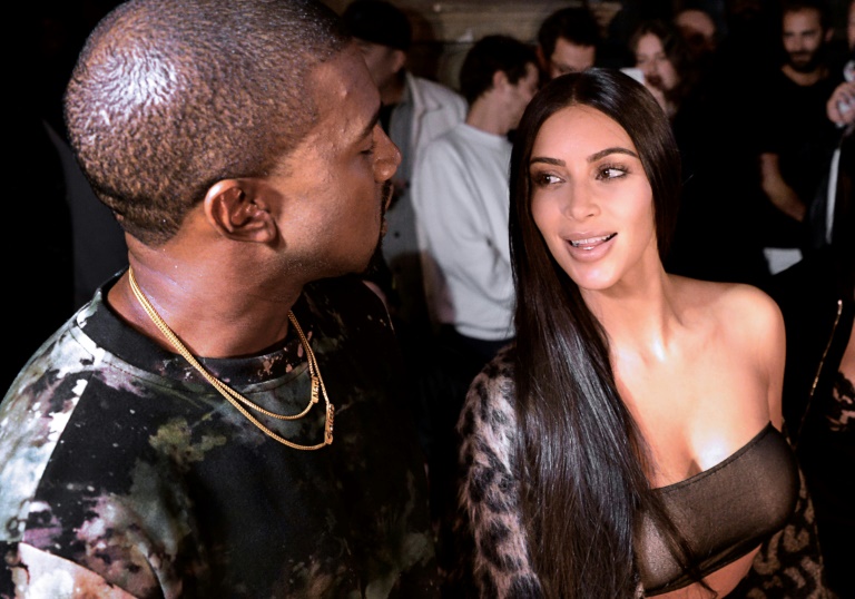 Kanye West and Kim Kardashian (right) pictured at a Paris fashion show on September 29, 2016