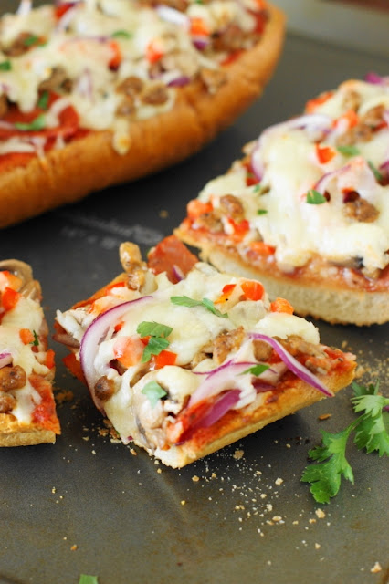 Easy Supreme French Bread Pizza ~ perfect for game-day snacking or an easy weeknight dinner! Loaded with great taste & ready in under 20 minutes.  www.thekitchenismyplayground.com