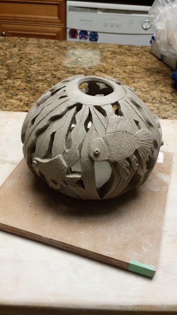 Ceramic handthrown carved pottery fish bowl sphere.