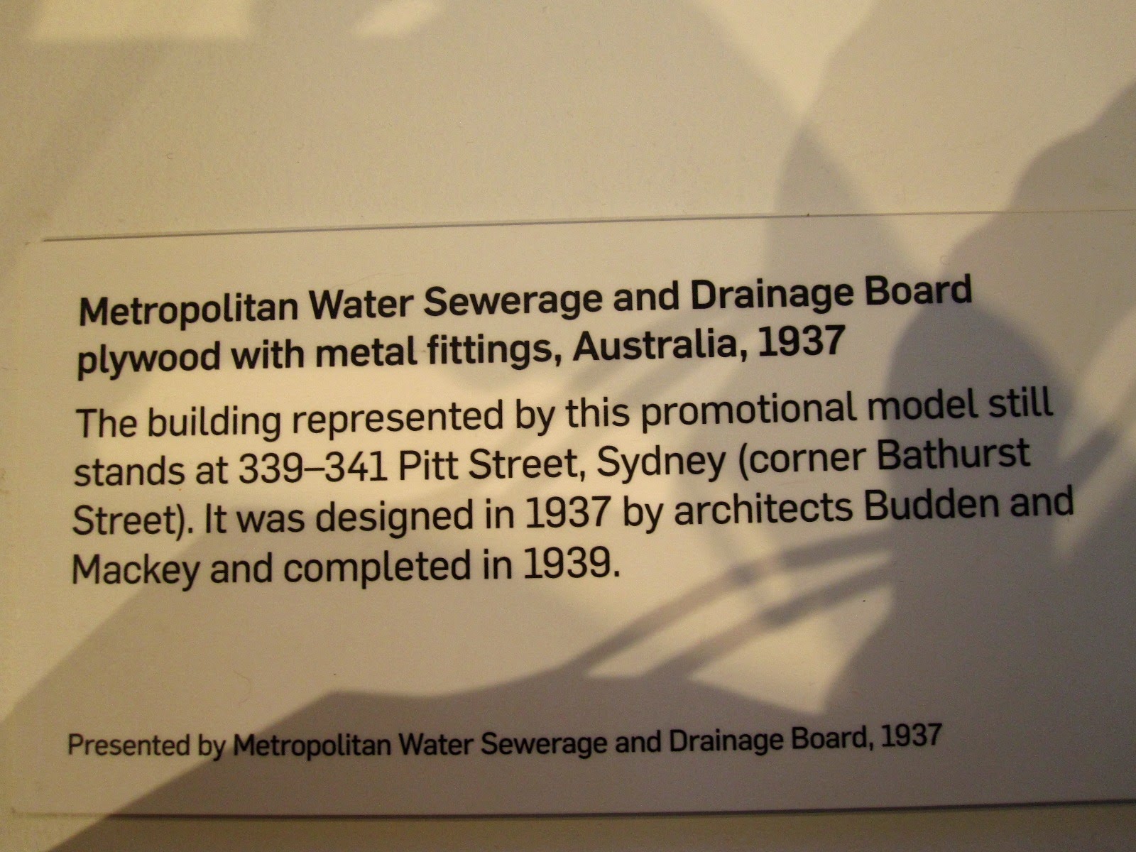 Exhibition sign for the model of the Metropolitan Water Sewerage and Drainage Board building.