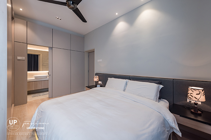 royal regent condo master bedroom with dark grey color cushion bedhead and partition with sliding door to bathroom