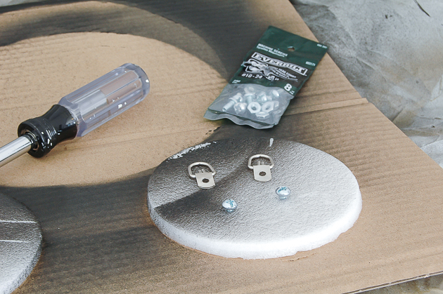 Spray painting hardware for captain's mirror