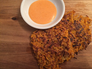 sweet potato panckaes on a cutting board with a bowl of dipping sauce