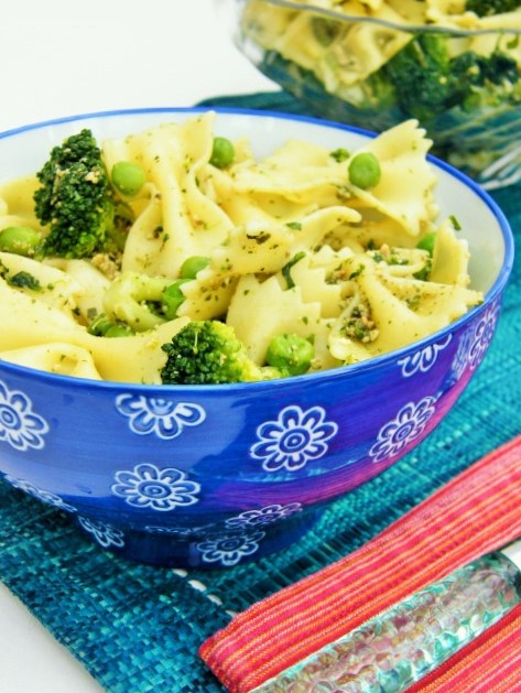 A flowery blue bowl filled with Green Goddess Farfalle with Dairy Free Pesto