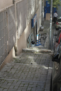 Shop entrance and narrow pavement.