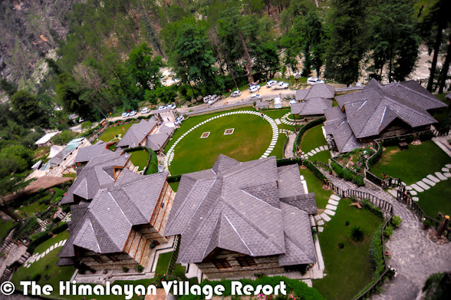 Want to enjoy Chamba, Kinnaur, Mandi, Kangra, Shimla, Spiti, Lahaul and Kullu at the same time? No I am not kidding! You could actually do that at the Himalayan Village Resort.And these are names of the cottages in the quaint resort, and captured the flavors of Himachal – the interiors, the food, entertainment-under one roof The resort, set amidst thick Deodar forest, helps you rediscover yourself, The serene mountain landscape of the land of gods and the unique architecture of Himalayan village resort- made of stone and wood-is so captivating that you many not want to go back to the city and its choresThe resort has been built in the ancient Kathkunia style –dry stacking stones and wood without cement. The inner walls are mud plastered to retain the native rustic charm. The resort is Eco-friendly and gives you an insight in the local customs and traditions. There are 8 cottages including two Machan- style rooms.The decor theme of each of the 750 sq ft cottage is built around the different culture flavors of Himachal Pradesh the decor of each room has been done up thematically, reflecting the tradition and culture of the state –deodar wood work, beautifully carved teak furniture, handmade Tussar silk curtains and traditional brass fittings give each room a cozy feel as you have come home. The resort provide daily housekeeping and evening turn down services.All cottages are equipped with a king size bed,4-seater sofa, study, mini Fridge ,mini bar, separate dressing area, fully furnished and equipped toilets and personal lawn. They also have private sit-outs. Lahaul and Kullu the Machan –Style cottages are the USP of the resort. They offer a sweeping view of the mountain landscape. Book the machans well in advance as they are most sought-after cottage because of their unique setting. The resort has mult-cusine restaurants, a well done up cozy bar that stocks finest liquor from around the world and a fully equipped spa to pamper you. The spa offers heat sauna, steam sauna, Jacuzzi aroma bath therapy, acupressure and massages and kero therapy.In case you planning a business gathering, the resort can accommodate different group size .It has world class facilities for organizing meetings. At the resort, you could be torn between staying indoors and going outdoors. If you are the outdoor types, the hotel can arrange many activities such as river crossing, rappelling, nature walks jungle excursions, rock climbing, mountain biking, trout angling, trekking and river rafting, horse riding, jeep safaris jungle barbecue.In case you feel like lazing around, simply sit in the private garden of your suite and let the sun-rays filtering through the Deodar tree play on you.A holiday at the resort and the cool greenness of Kullu with its wide range of trees, ferns and native flora will act like balm for your dust-weary soul. That‘s a promise!Just look at the right-bottom corner of above photograph, which shows the location on a hill where 'The Himalayan Village Resort'  is located.The Himalayan Village is one of the premier holiday resorts in Himachal Pradesh offering exciting Himachal tour packages.The Himalayan Village is a glorious mix of style, top class facilities, where the traditional architecture & aesthetics blend harmoniously. 'The Himalayan village' is an ideal place to rejuvenate amongst nature and its ways. Sitting under deodar jungle in the morning hours with the sunrays breaking through brings with it the peace of nature. 'The Himalayan Village' situated at the foothills of the famous malana village, the oldest democracy in the world & just 10 K.M short of manikaran, famous for its hot water springs, right on the bank of ice cold parvati river. A highly revered pilgrimage being the tapobhoomi of Bhole Nath for 11000 years & later visited by the great Sikh guru Sh. Gurunanak dev ji. The valley has some real good treks, majestic flower valleys, thick flora and fauna, crystal clear waterfalls, rivers in virtuous serine parvati valley the 'tapobhoomi' of shiv shamboo. The village has thick deodar (pine) forest as the crown, river parvati wetting its feet, mountains made of black hard-rock, wih as many features as one’s mind can think of protruding as lingas in different shapes & sizes. Snow covered peaks making a perfect backdrop for this 'Shiv Nagari'. The village is a perfect place for nature lovers. The sights of day break, sunrise, and crystal clear skies full of numerous stars can remain etched in one’s memory forever.Made in pure traditional & ancient Kathkunia style (dry stacking of stone & wood without cement), with mud plastered walls from inside blending perfectly with deodar wood work, beautifully carved teak furniture, handmade tussle silk curtains, traditional brass fittings make a perfect blend of aesthetics and class. The cottages based on different districts of Himachal have a build in area of 600- 750 sq ft with mini bar, mini fridges, study, separate dressing, fully furnished and equipped toilets and personal lawns.The Himalayan Village has multiple restaurants, a beautiful traditional bar, a spa with heat sauna, steam sauna, Jacuzzi, aroma bath therapy, kero therapy, acupressure, and massaging to take care of you after a day of activities like river crossing, rappelling, nature walks, jungle incursions, rock climbing, mountain biking, trout angling, trekking, orchard picnics, rafting. After refreshing your mind and soul, join us for the traditional folk dances of himachal done by 'we the staff' and polish off the day with the mouth watering cuisines of himachal. 'The Himalayan village' is real insight to the lifestyle, culture, cuisines, architecture of We 'Pahari people' We promise you all a true Pahari warmth and love.
