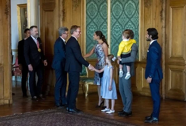 Crown Princess Victoria wore Oscar De La Renta Floral Print Dress, Yves Saint Laurent Suede Pumps, carries Quidam Clutch. Princess Estelle, Prince Oscar