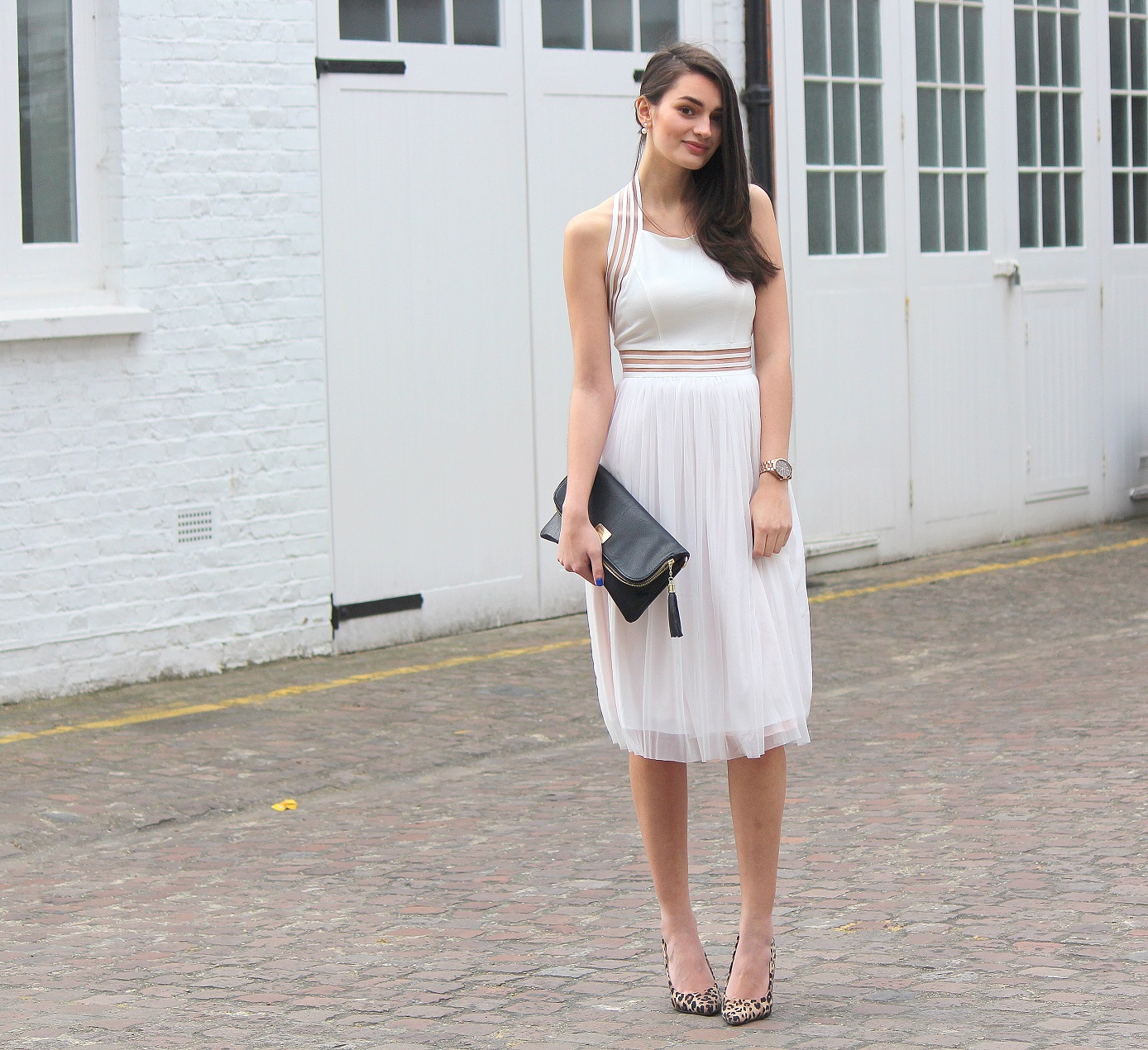 peexo fashion blogger wearing white backless dress and leopard print heels and black clutch in spring