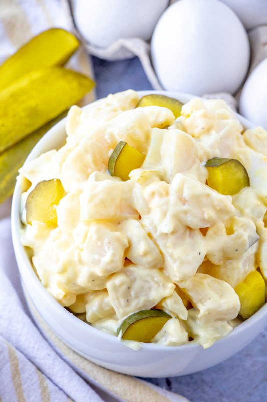 Dill Pickle Potato Salad! Sure to be a new family favorite! The tangy flavor of the dill pickles adds a delicious pop of flavor to this salad! Make it for your next picnic or BBQ!