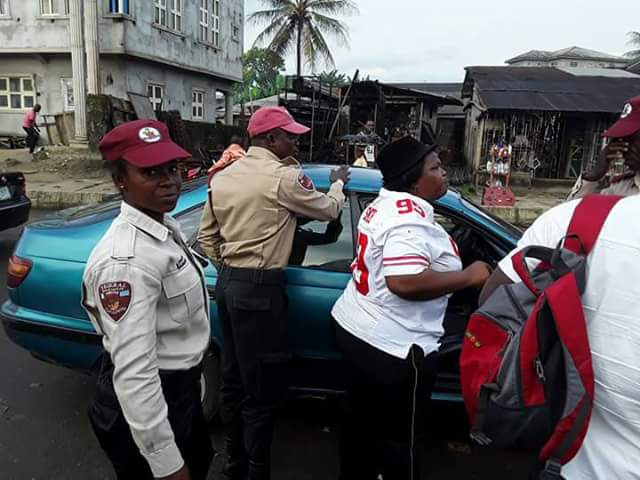  Photos: Female FRSC official in Akwa Ibom pictured dragging steering wheel with a driver in moving vehicle