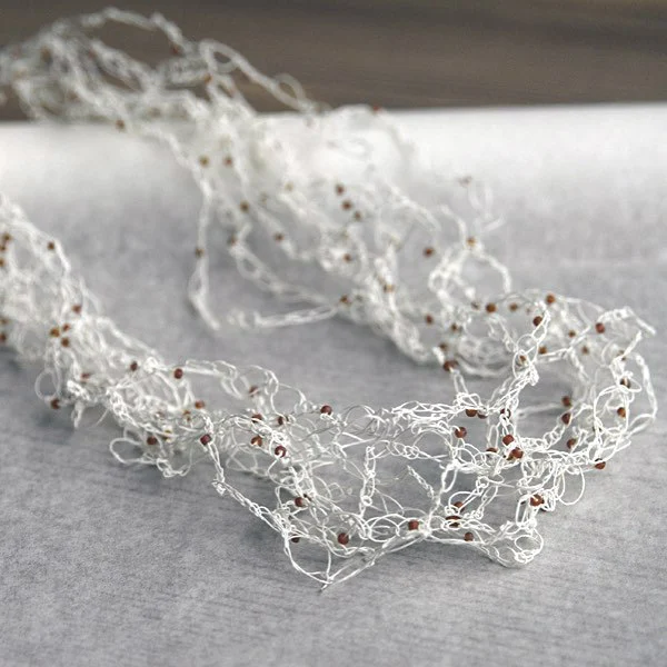 Crocheted Fine Paper Yarn Necklace is white with tiny glass seed beads
