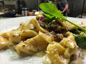 House-Made Pasta* Carbonara: Pork Cheek, Black Pepper Butter, Pea Shoots, Goat's Milk Cheddar, and Toasted Breadcrumbs. *Pasta Noodles made Fresh to order.
