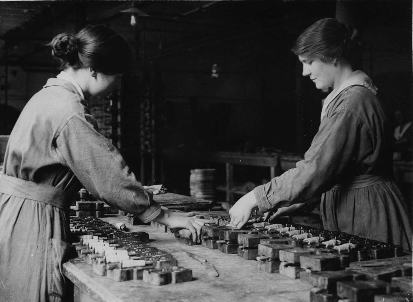 Rubber workers in Lancashire make mouthpieces for gas masks.