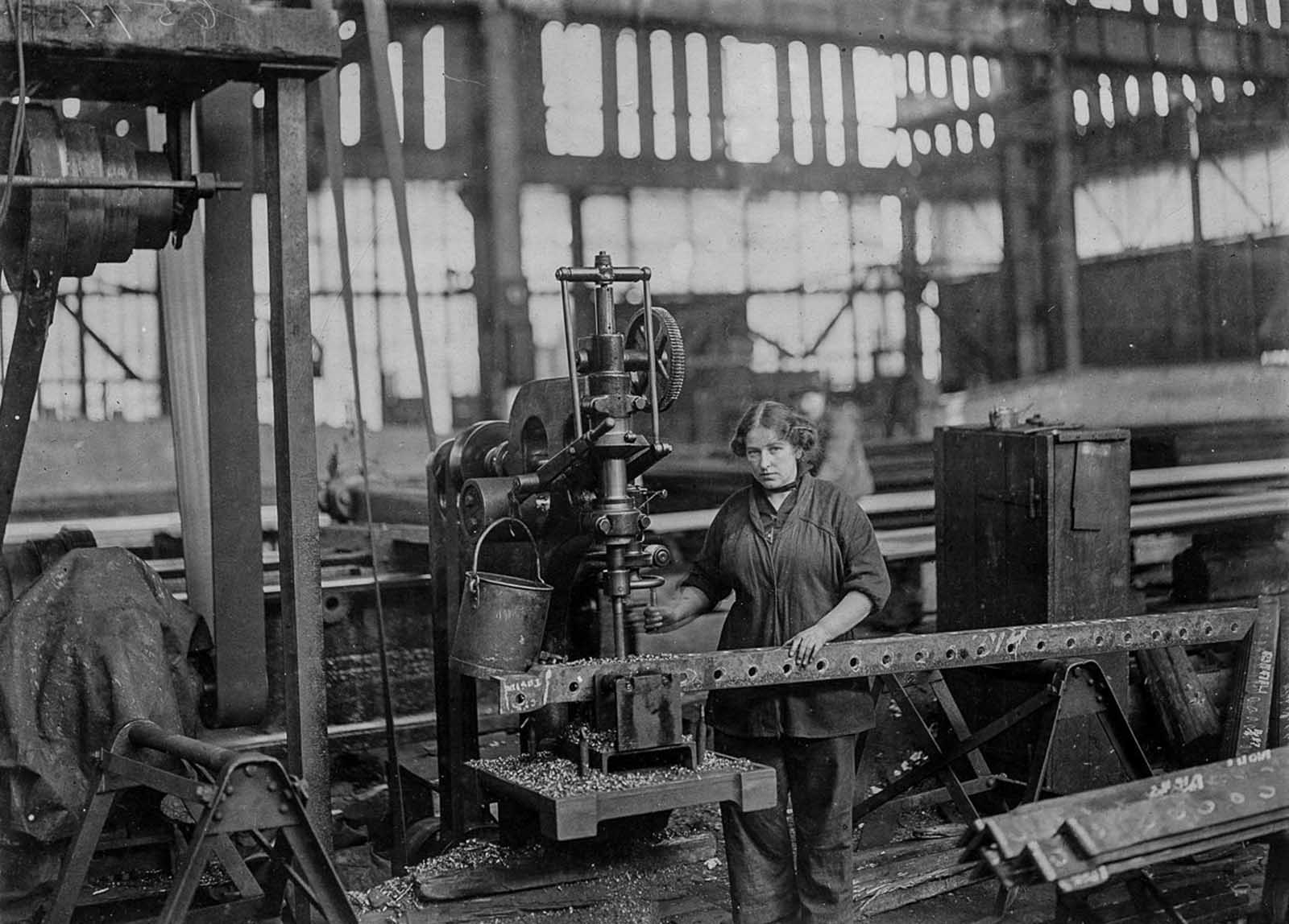 A worker drills holes for the ribs of airship sheds.