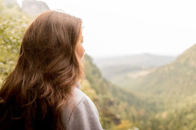 woman hiking looking at mountains