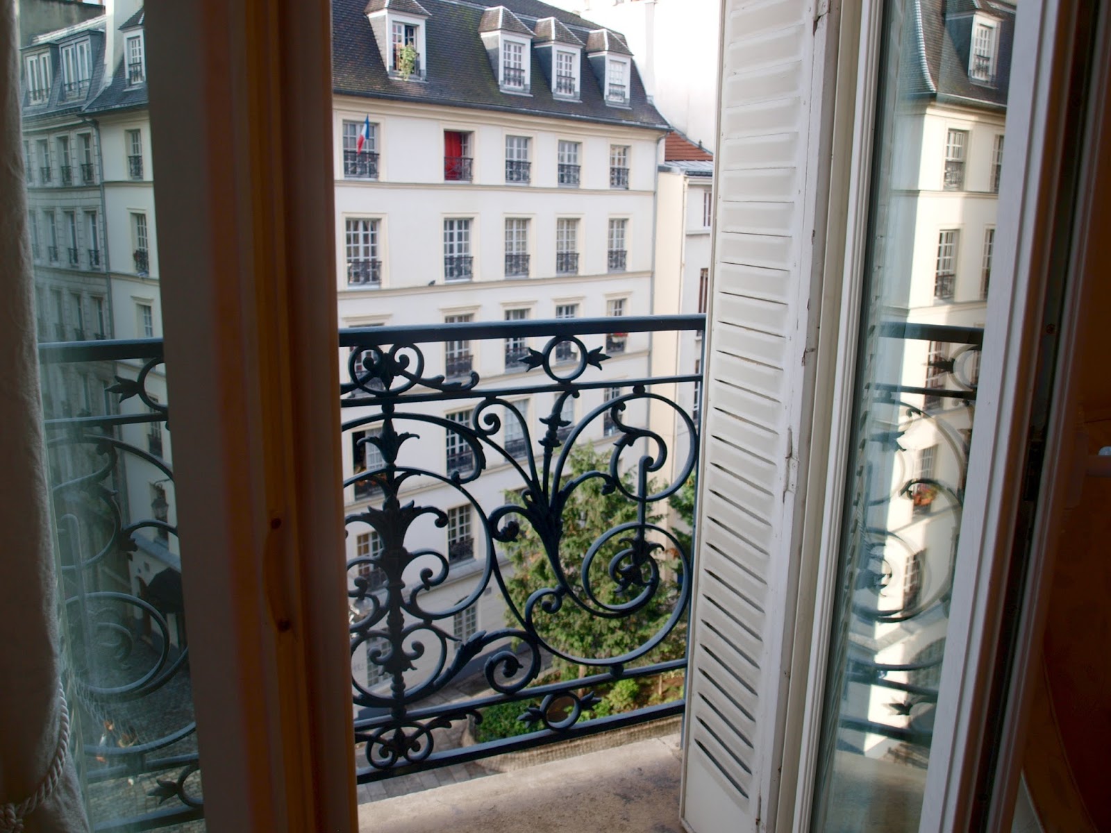 French doors to balcony in our Paris apartment - by Hello Lovely Studio