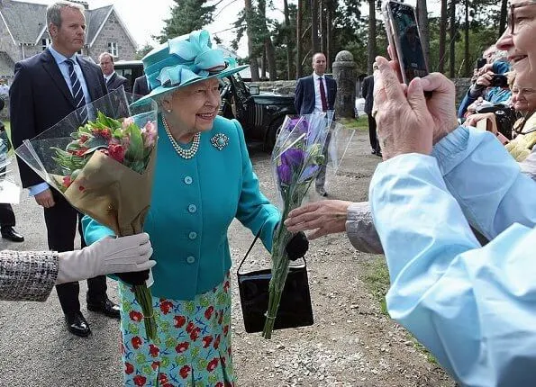 Queen Elizabeth opted for a silver and turquoise broach which she wore on the left side of her fitted blazer at Balmoral