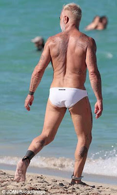 Italian millionaire, Gianluca Vacchi, 49, shows off his beach body in a tiny pair of white swimming shorts